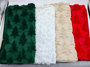 Detail showing plush Christmas tree pattern on green, white, beige, and red pillowcases