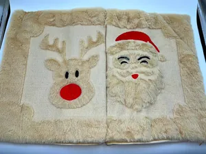 Detail of Christmas plush pillowcases featuring Santa and reindeer quilted designs.