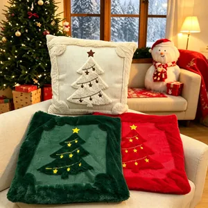 Close-up of festive Christmas cushion covers with quilted trees and plush faux fur borders.