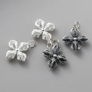 Detailed view of 925 sterling silver vajra pendants in shiny and antique finishes.