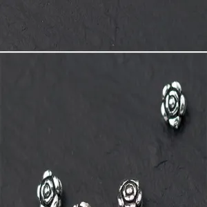 Detailed macro shot of S925 Thai silver rose flower spacer beads for DIY jewelry making