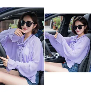 Model wearing a purple chiffon UV protection shawl while driving in a car interior
