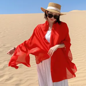 Elegant vibrant red chiffon sun protection shawl for desert photography and travel