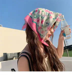 Elegant floral cotton linen square scarf worn as a stylish headwrap under a bright blue sky