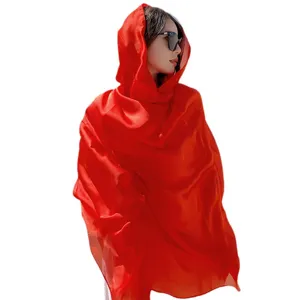 Vibrant red lightweight silk-like sun protection shawl for beach travel and photography.