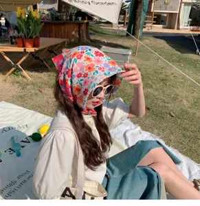 Floral cotton-linen square scarf worn as a stylish headscarf for outdoor picnic