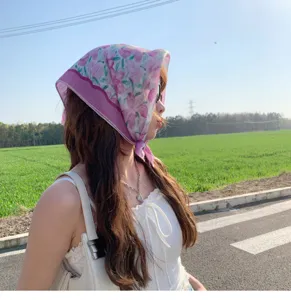 Floral pattern cotton linen small square scarf worn as a headscarf in an outdoor setting