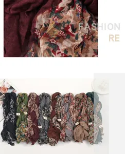 Detailed view of lightweight floral cotton linen pleated scarves in multiple colors