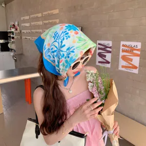 Asian model wearing a fresh blue floral cotton linen square scarf as a stylish headwrap