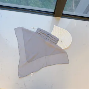 Detailed view of the lightweight gray sun protection veil with full neck coverage