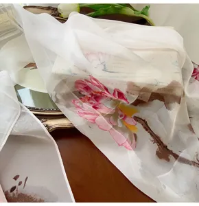Detailed macro view of sheer Georgette silk scarf with artistic lotus flower print