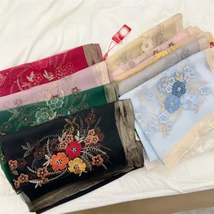 Multi-color silk blend scarves with delicate begonia flower embroidery and gold trim detail