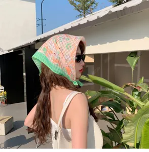 Detailed view of fresh floral cotton linen headscarf worn by model outdoors