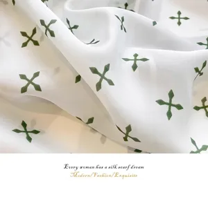 Detail shot showing the soft texture and green print of a 70cm silk-like scarf.