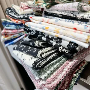 Detailed view of stacked 100% cotton floral handkerchiefs with delicate lace trim