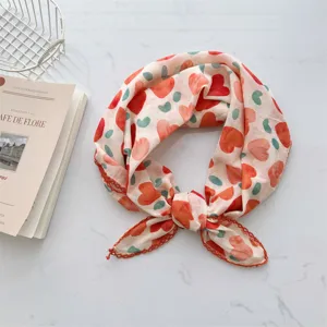Detail of cotton neckerchief with red heart pattern and crochet lace trim edge