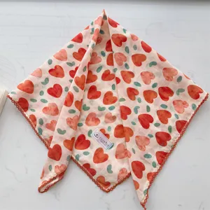Detailed view of a 100% cotton square scarf featuring a red heart print and lace trim