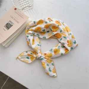 Detailed view of soft 100% cotton neckerchief with yellow hearts and green dots