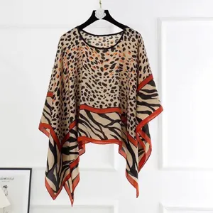 Detailed view of the leopard and zebra print pattern on the light faux silk shawl