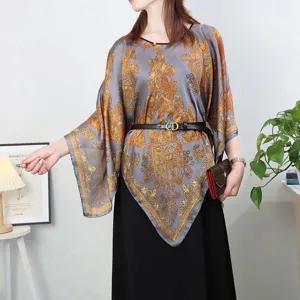 Detail view of a stylish printed faux silk pullover shawl with gold baroque patterns
