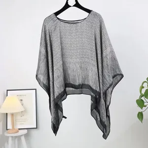 Detail view of the elegant grey patterned sheer poncho for women's beachwear.