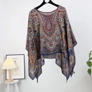 Detailed view of women's ethnic paisley print sun protection pullover poncho cover-up