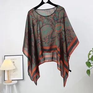 Elegant teal paisley print silk-like poncho shawl for sun protection and beachwear.