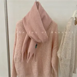 Detail view of a soft pink wool-blend scarf featuring cute girl embroidery work.