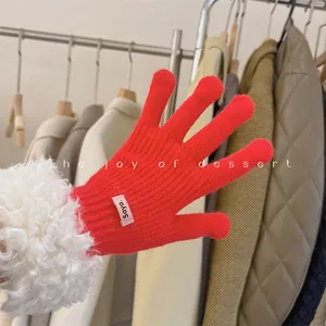 Detailed close-up showing the red knit texture and soft white faux fur cuff of a winter glove.