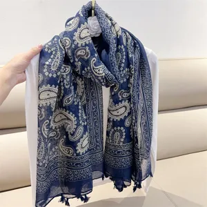 Detailed macro view of navy blue paisley bohemian scarf with decorative tassels