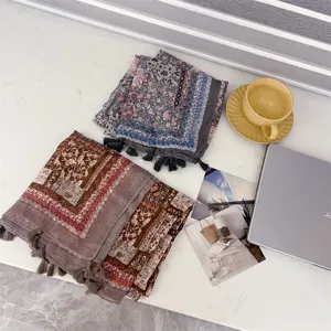 Detailed macro view of vintage ethnic scarves with geometric paisley prints and tassels