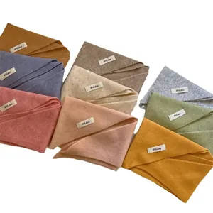 Assorted colors of wool blend knitted triangular headscarves with labels on white background