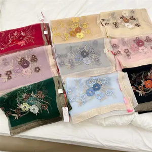 Collection of various colored silk blend scarves with floral embroidery details