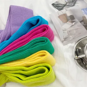 Detailed view of colorful knitted arm warmers with ribbed texture in vibrant hues