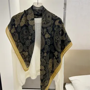 Close-up of a 90cm cotton linen square scarf featuring elegant golden paisley prints.