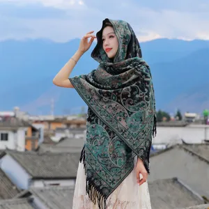 Ethnic paisley shawl for winter travel, thick scarf with tassels worn by model