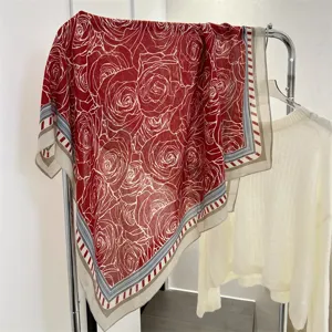 Detailed view of red cotton linen square scarf with elegant white rose floral patterns