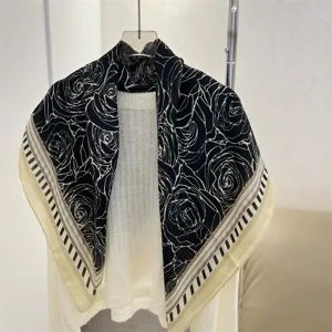 Close-up of a 90cm square scarf featuring a black and white rose pattern