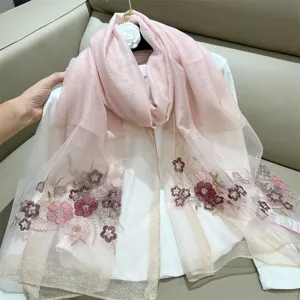 Detail view of pink silk blend scarf featuring elegant embroidered crabapple flowers