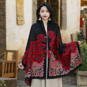 Detailed view of an ethnic style shawl with red floral patterns on black