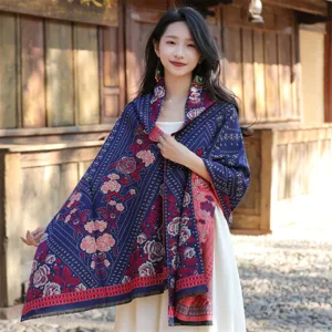 Detailed macro view of a thick ethnic floral shawl worn by a model in a rustic setting.