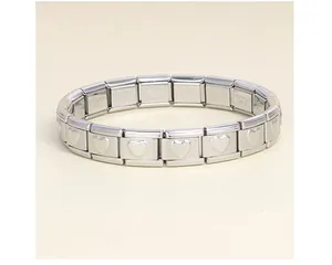 Detailed view of a silver stainless steel Italian charm bracelet with heart patterns