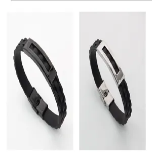 Detail view of men's punk style silicone and stainless steel bracelets in black and silver