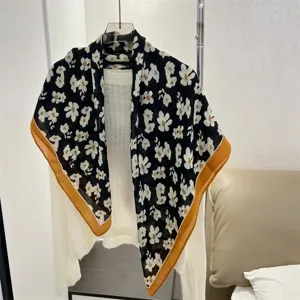 Detailed view of a cotton linen square scarf with white floral pattern on black background