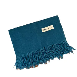 Solid teal blue imitation cashmere scarf with tassels and minimalist label tag detail
