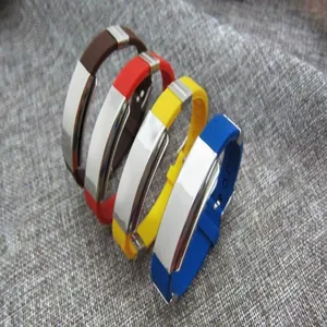 Detail view of four colorful silicone and stainless steel engravable couple bracelets