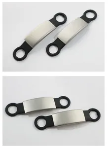 Detailed view of brushed metal pet ID tags with flexible black silicone loops