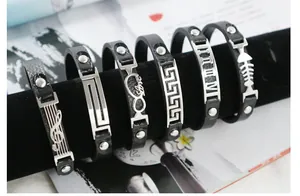 Detailed view of black leather bracelets with various stainless steel charm designs.