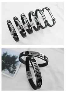 Close-up detail of titanium steel leather bracelets with diverse metal engravings