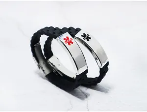 Macro view of stainless steel medical alert symbols on black silicone bracelets.